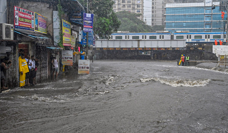 Heavy Rain Lashes Mumbai Many Areas Inundated Local Train Services